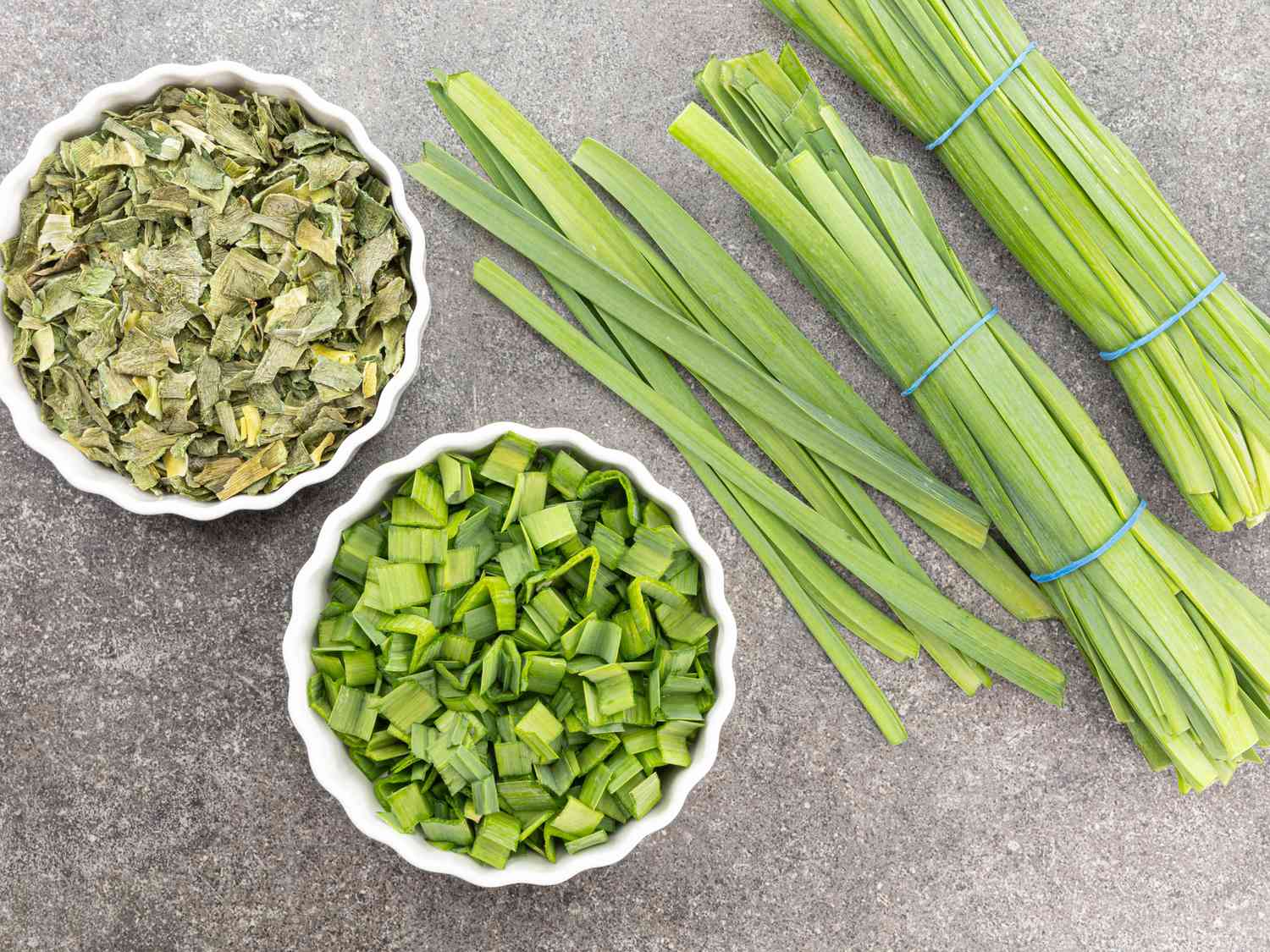 fresh herbs in small bowls and in bundles 