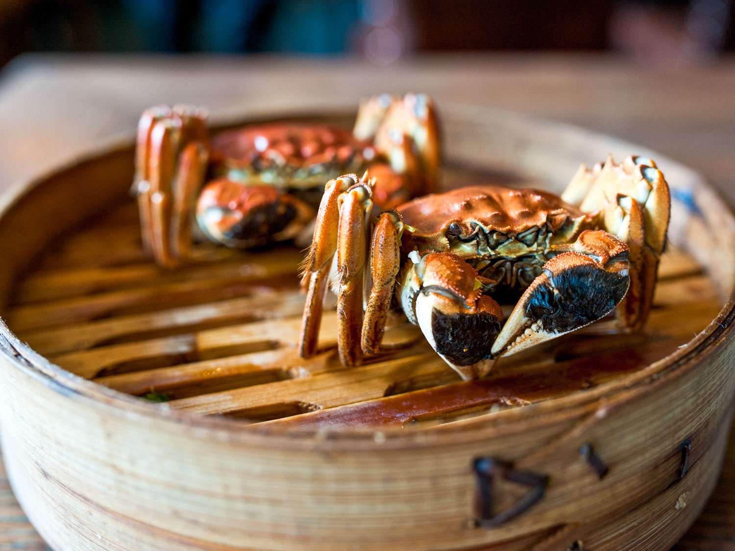 Two hairy crab on top of a steam basket 