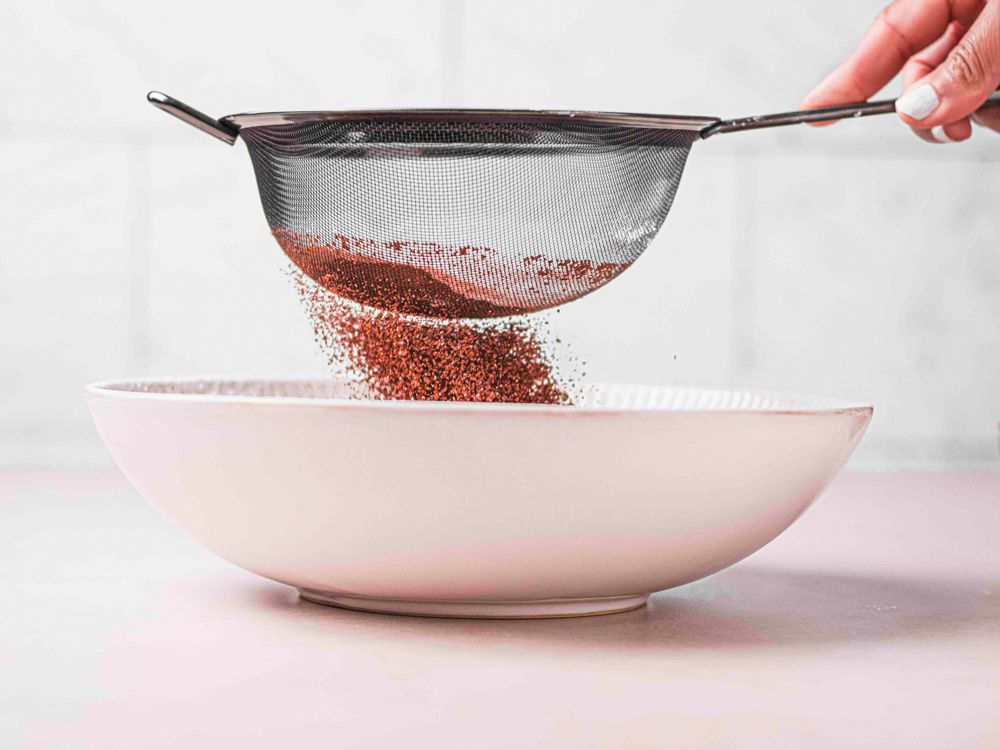 Side view of sifting chocolate