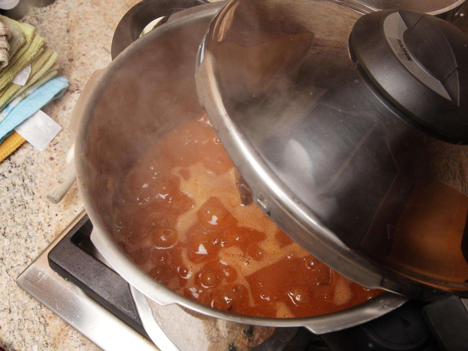 The cooker has been depressurized. The lid is removed and the sauce is reduced.