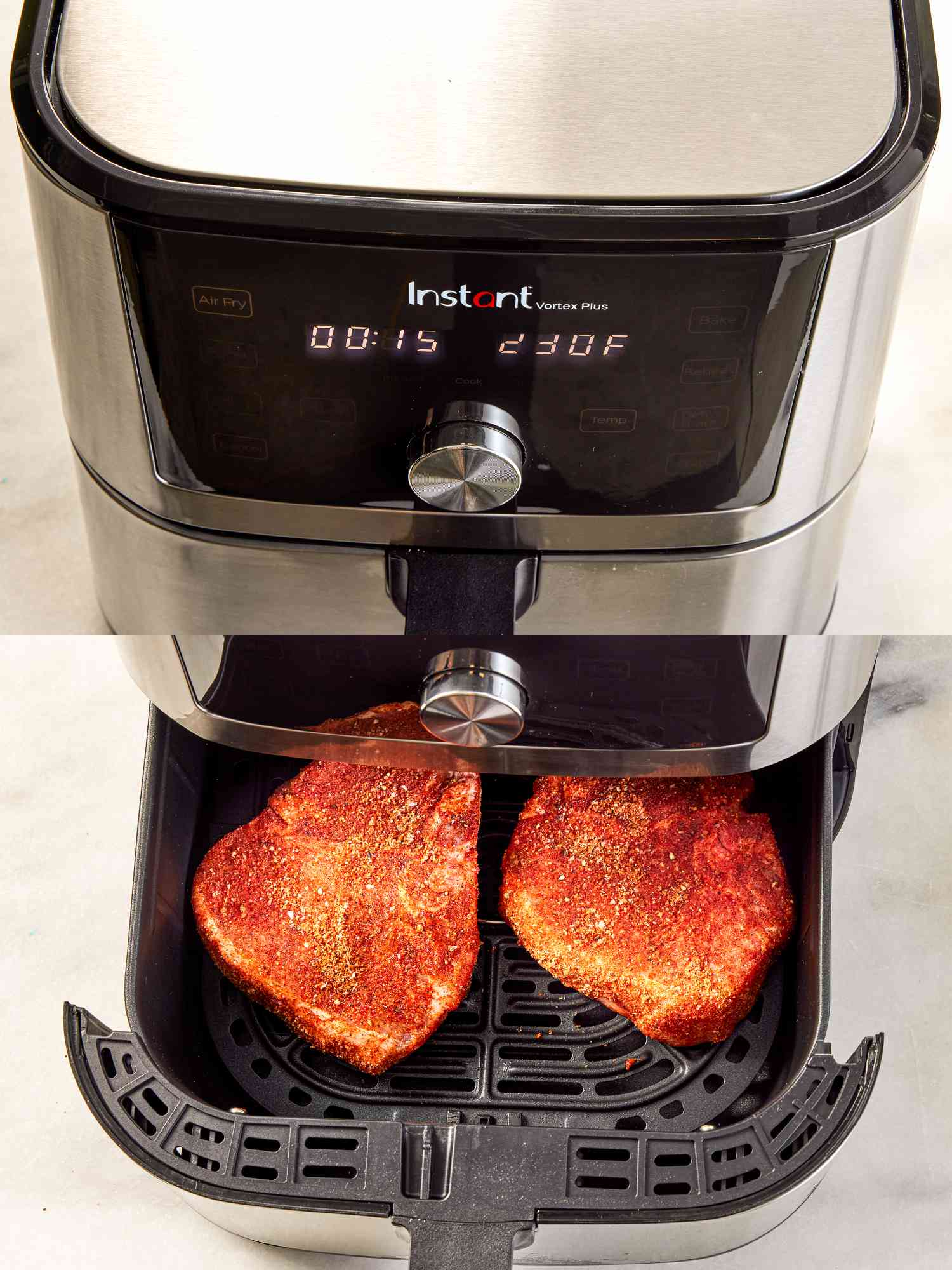 Placing two pork chops in an air fryer.