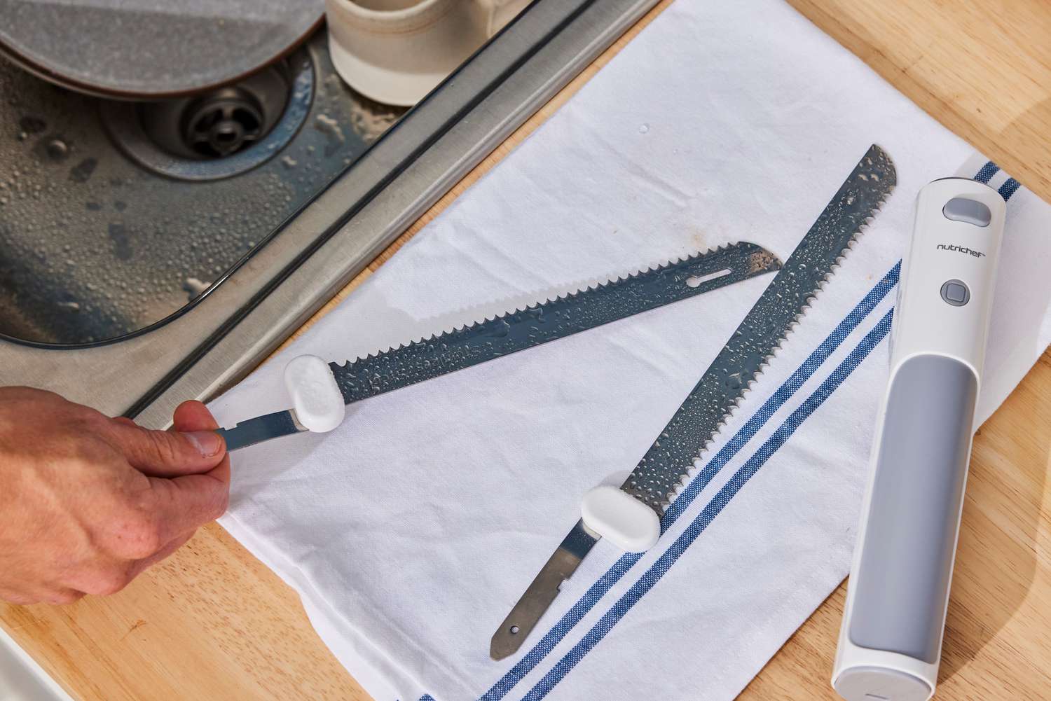 a person washing the blades from the nutrichef slicer