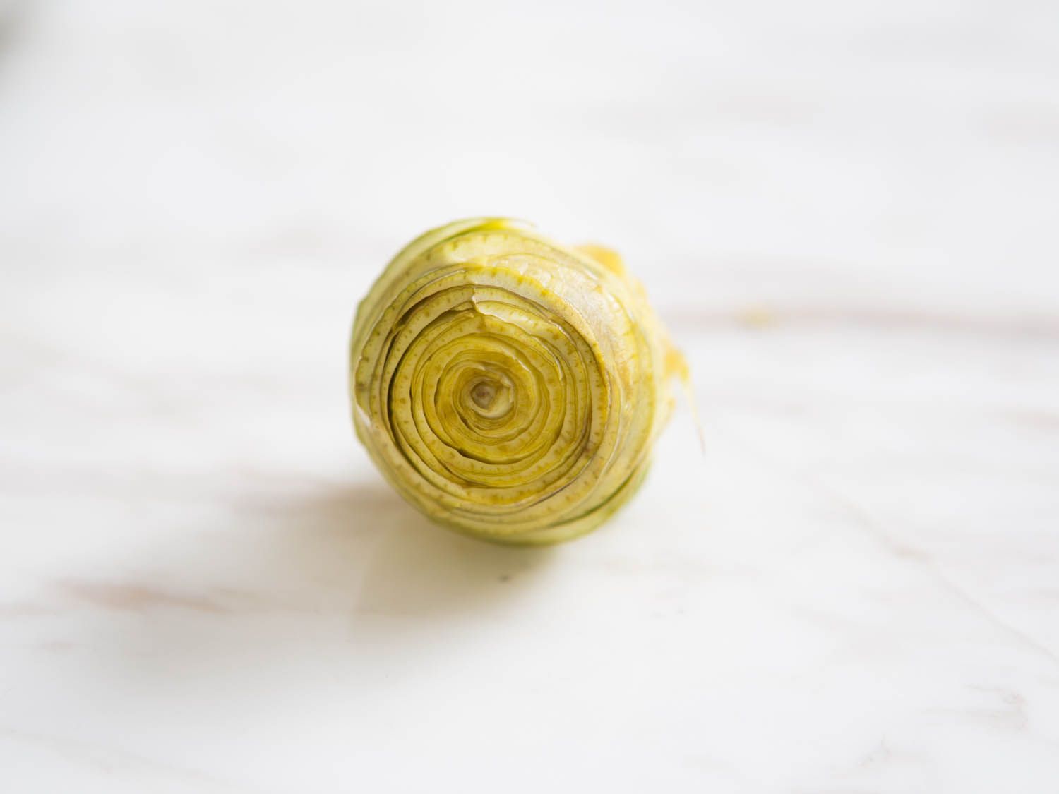 Close-up of a fully trimmed baby artichoke.