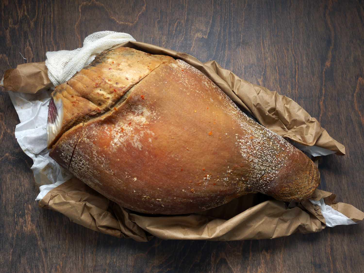 Benton's country ham on it's wrapping on a wooden surface