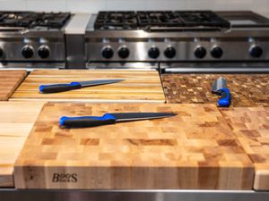 Chef's knives on the best wooden cutting boards in a kitchen