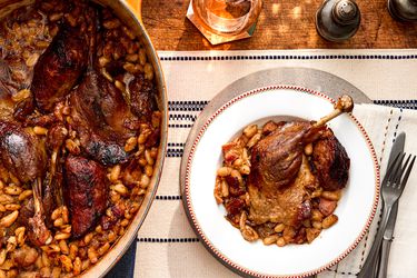 Overhead view of a single single serving of traditional French Cassoulet next to the pot.