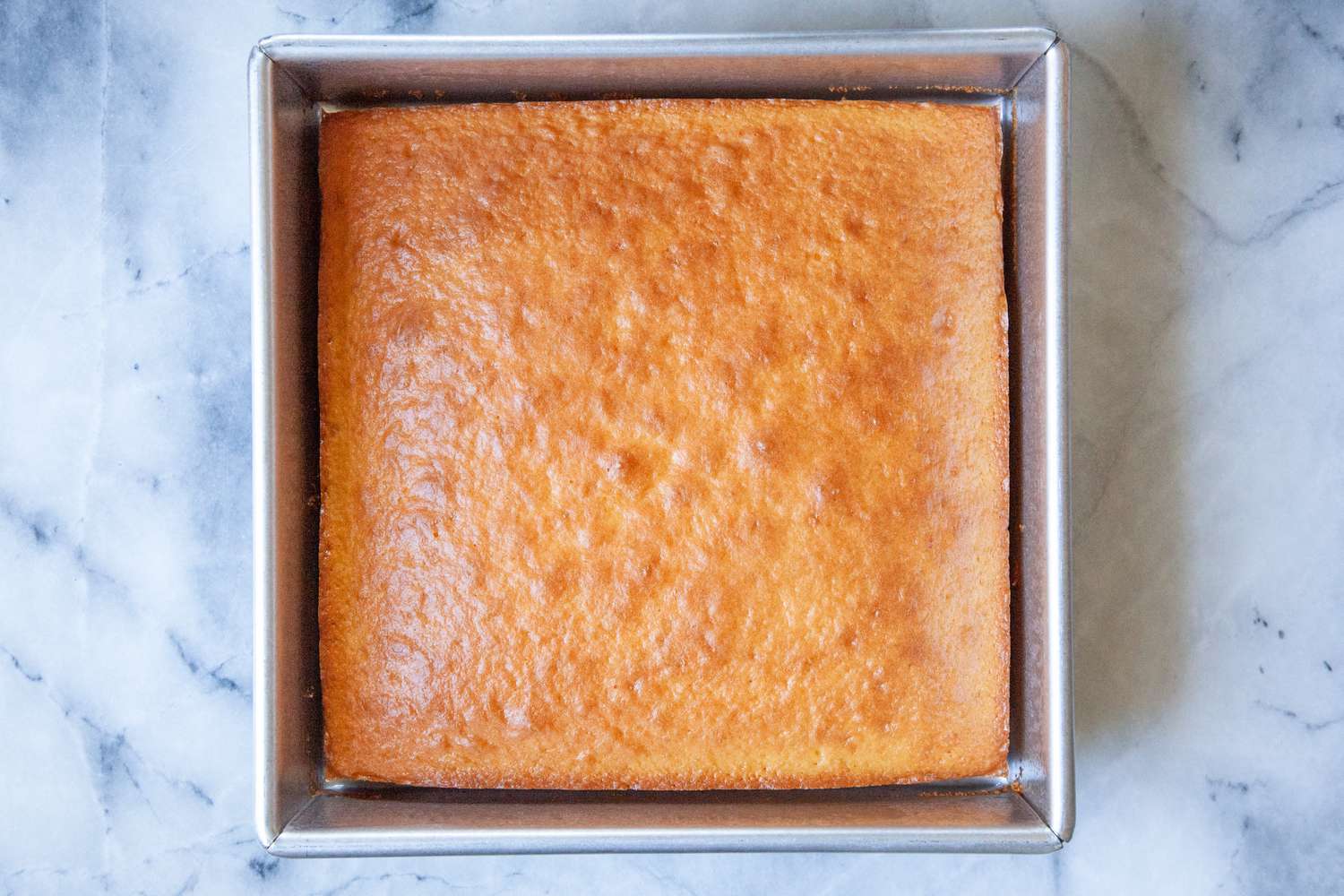 The Williams Sonoma baking pan with a yellow cake in it.