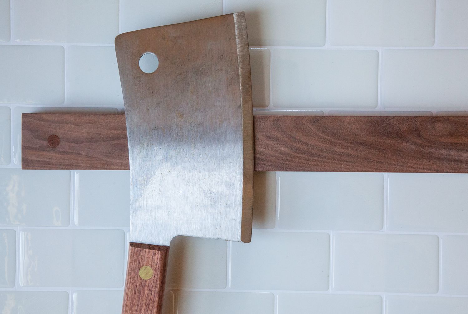 Closeup of cleaver attached to wooDsom Customized Magnetic Knife Strip