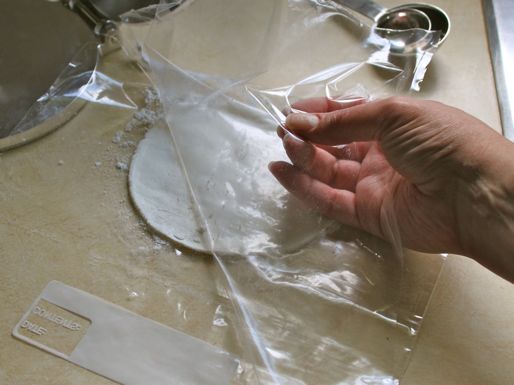 Author peels the plastic from one side of a tortilla.