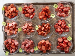 Small bowls of hot dog slices labeled with numbers
