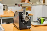The Weston #8 Electric Meat Grinder on a kitchen countertop