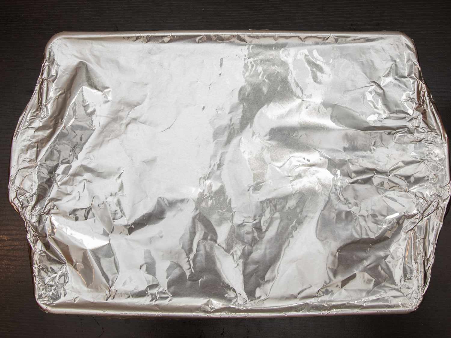 Overhead view of pan covered in tin foil