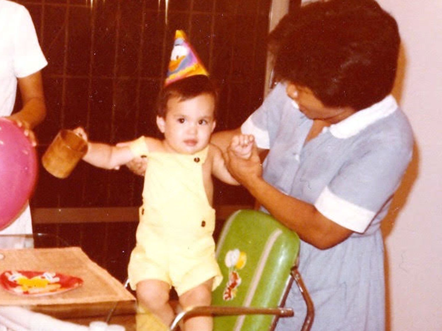 a young Sho Spaeth being held up by Erlinda