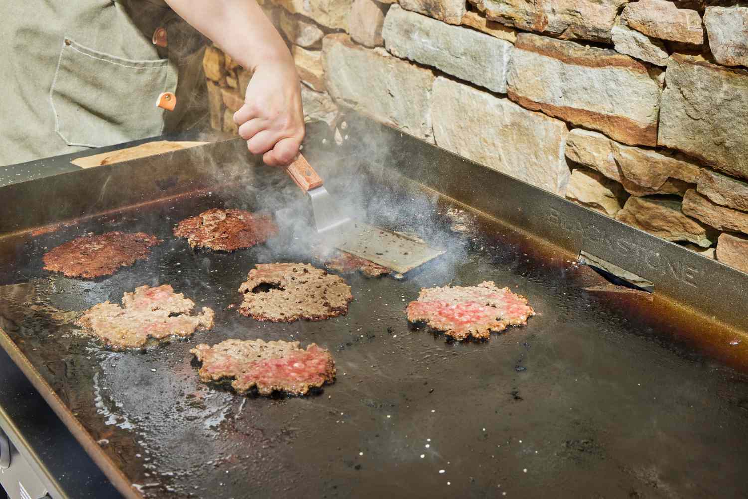 Smashburgers are made on the Blackstone 1554 Cooking 4 Burner Flat Top Gas Grill