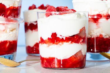 Eton mess desserts in glasses, layered with cream and strawberries