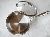 The Zwilling saucepan and its lid on a marble countertop.