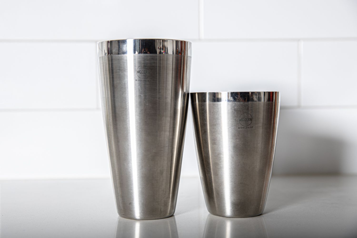 The Modern Mixologist tins on a grey countertop