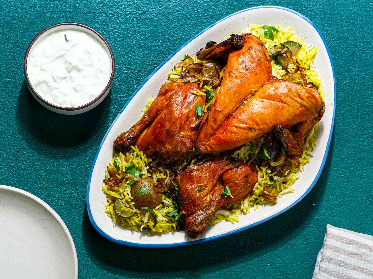Overhead view of Biryani Style Roast Chicken against a blue background