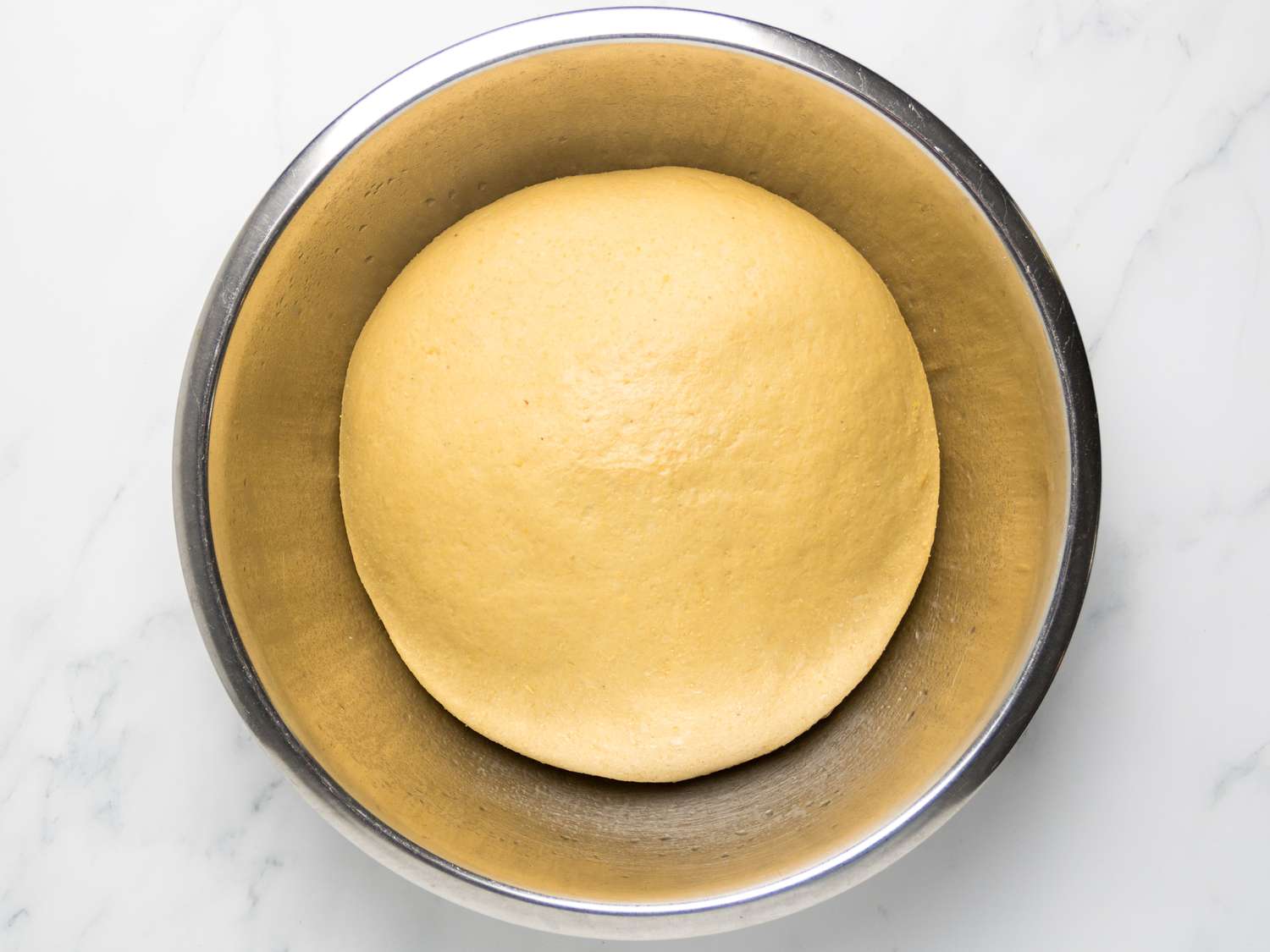 dough after proving in metal bowl 