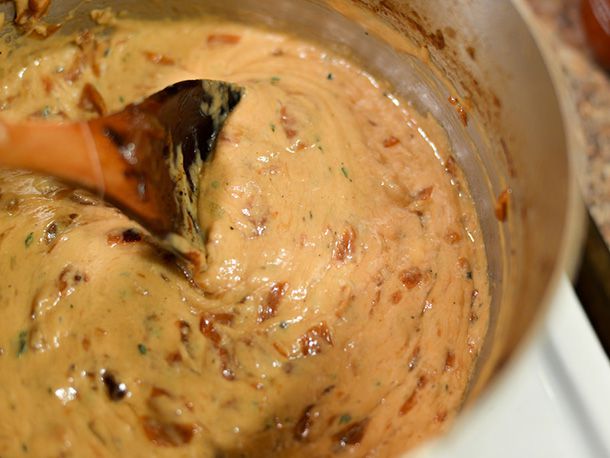 Closeup of the finished dip being stirred in a saucepan.