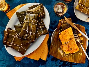 Plates of hallacas wrapped and unwrapped traditional Venezuelan tamales
