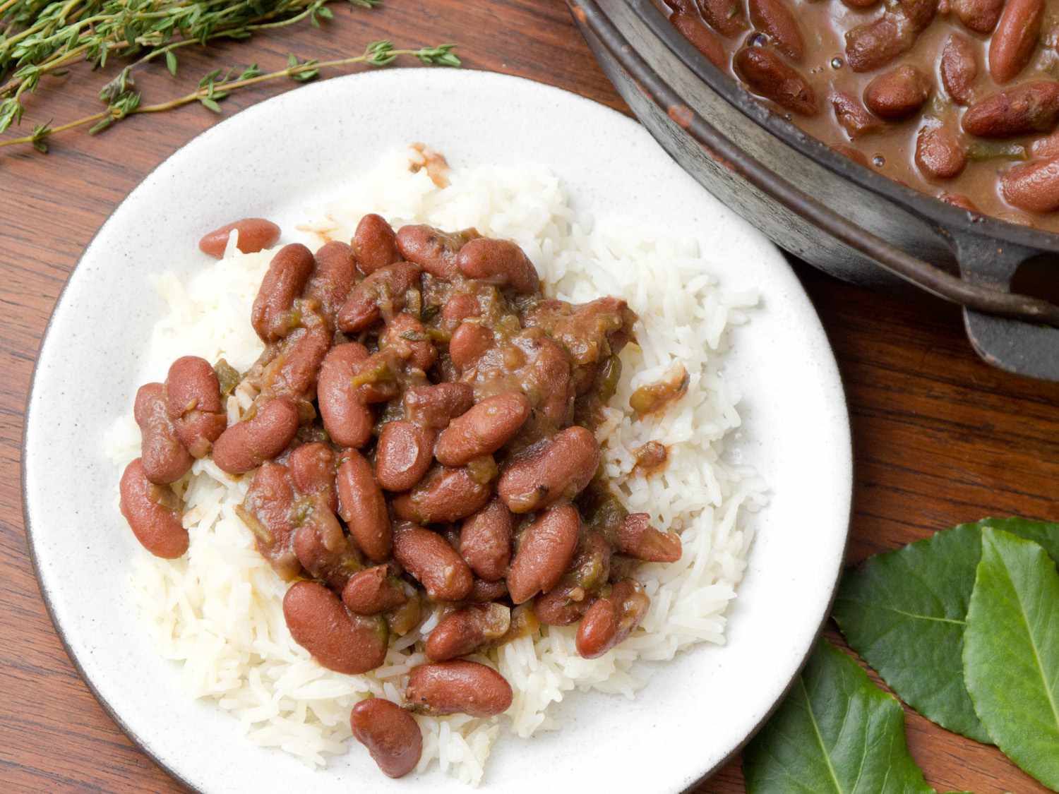 A plate of rice with red beans and smoked turkey. 