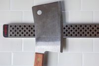 Closeup of cleaver attached to Global Magnetic Knife Strip