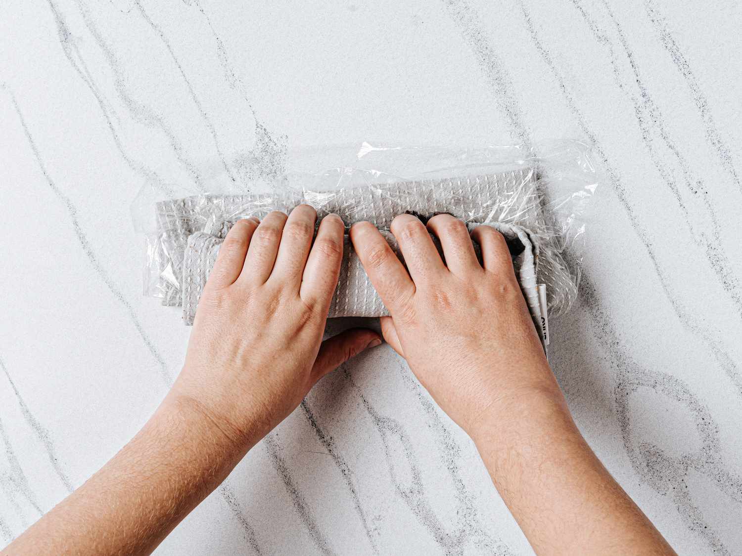 Hands rolling over rice to wrap over filling 