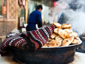 samsas, unleavened pockets of wheat dough that are filled with mutton, folded over like envelopes, and then baked in a deep outdoor pit