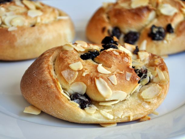 Closeup of cherry almond buns served on a white plate.
