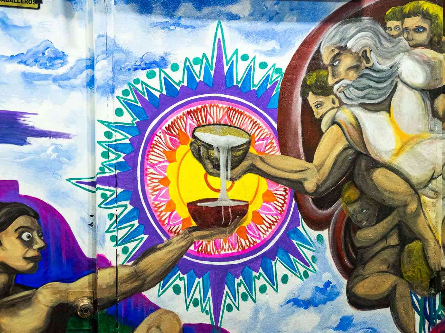 A mural in La Cátedral del Pulque showing God pours pulque from his jicara, a traditional drinking vessel made from a gourd, into one held out by Adam.