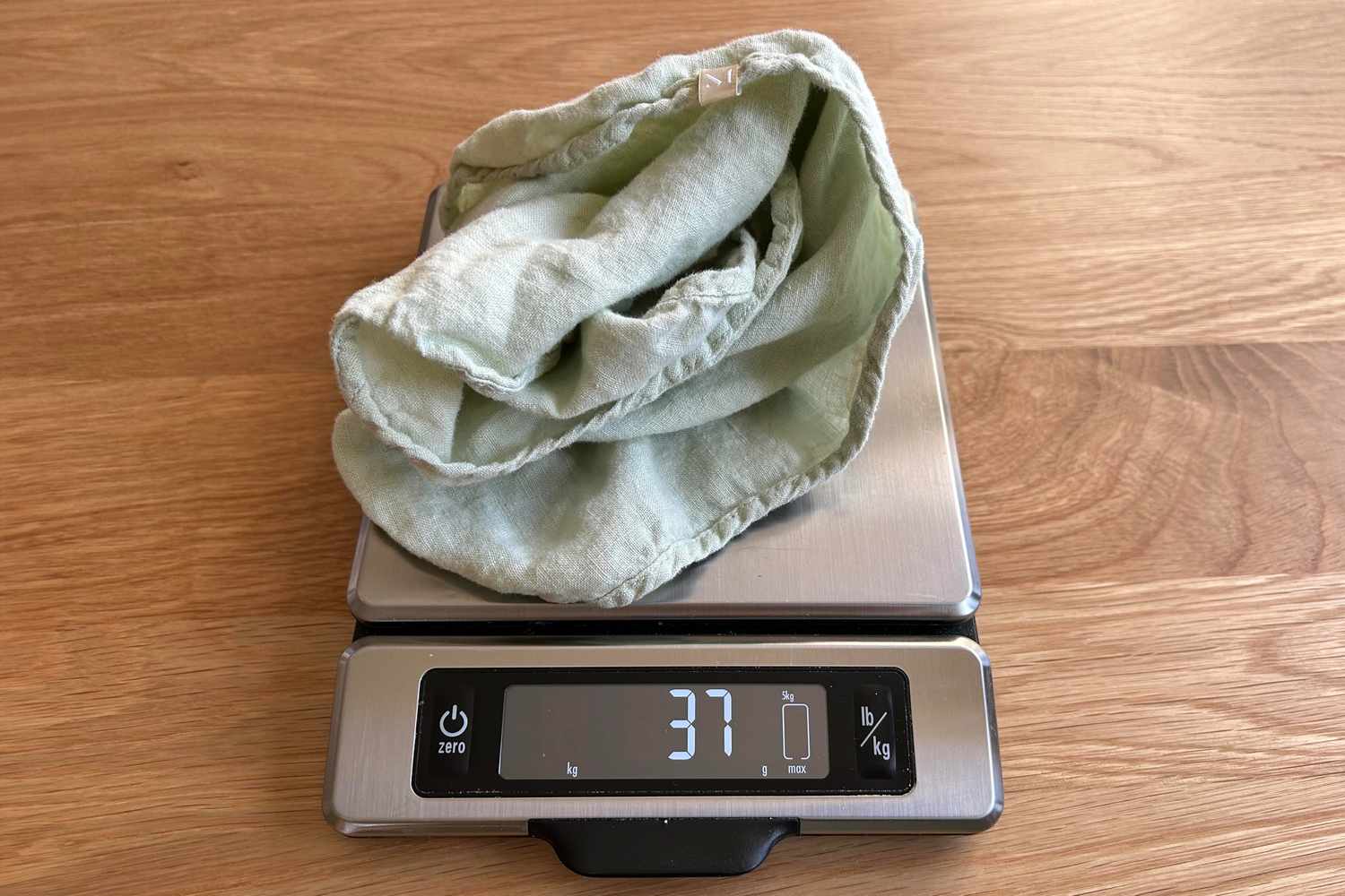 Green Cloth Napkin placed on scale