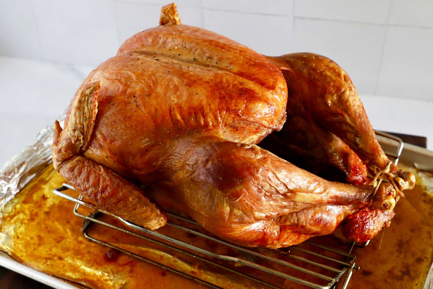 A whole roasted turkey on a rack in a baking pan