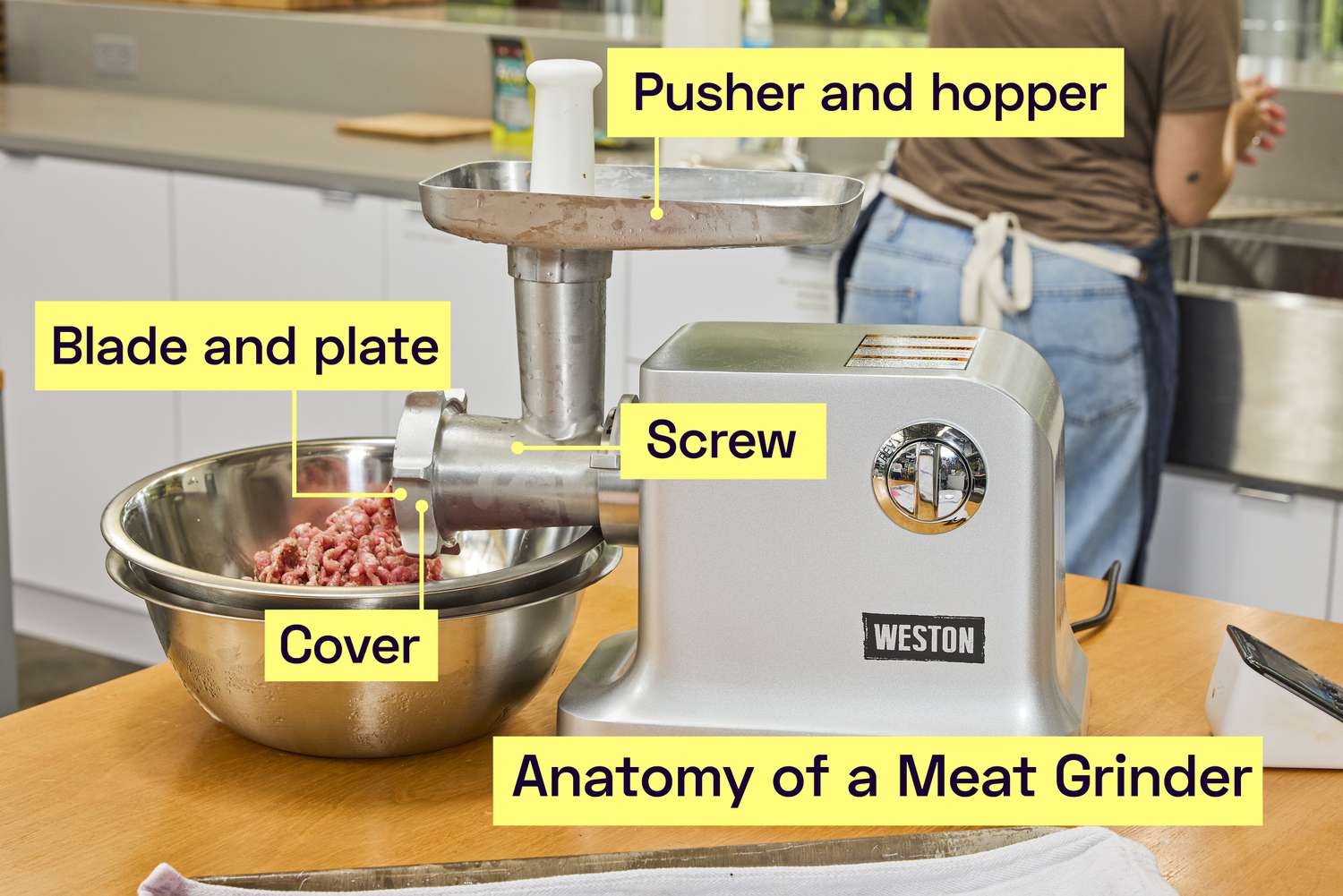 Meat being ground with a meat grinder.