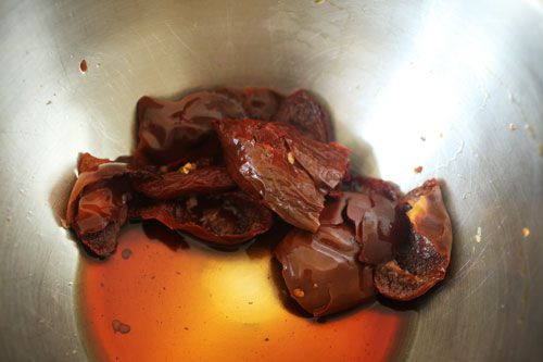 Closeup of rehydrated and drained chiles in a prep bowl.