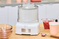 The Cuisinart 1.5-Quart Ice Cream Maker on a wooden counter