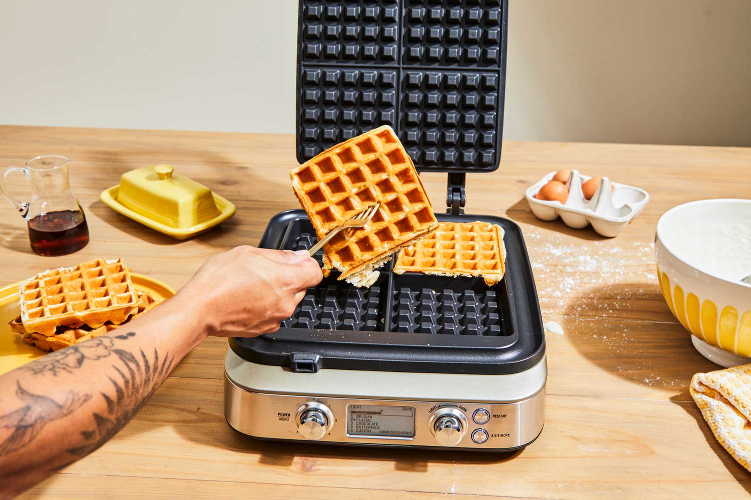 Person holding waffle made in Breville The Smart Waffle Pro 4-Slice Waffle Maker