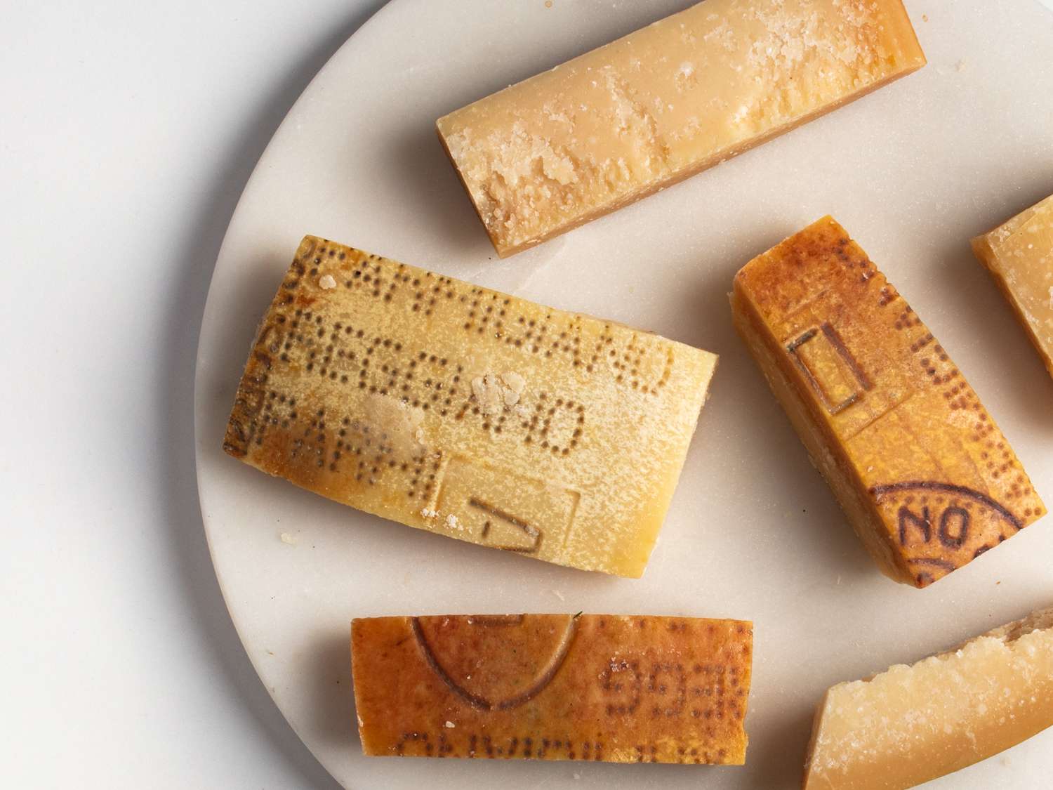 discarded rinds of parmesan cheese on a marble board