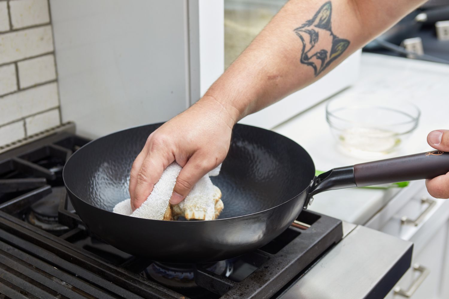 Person cleaning the Souped Up Recipes Carbon Steel Wok