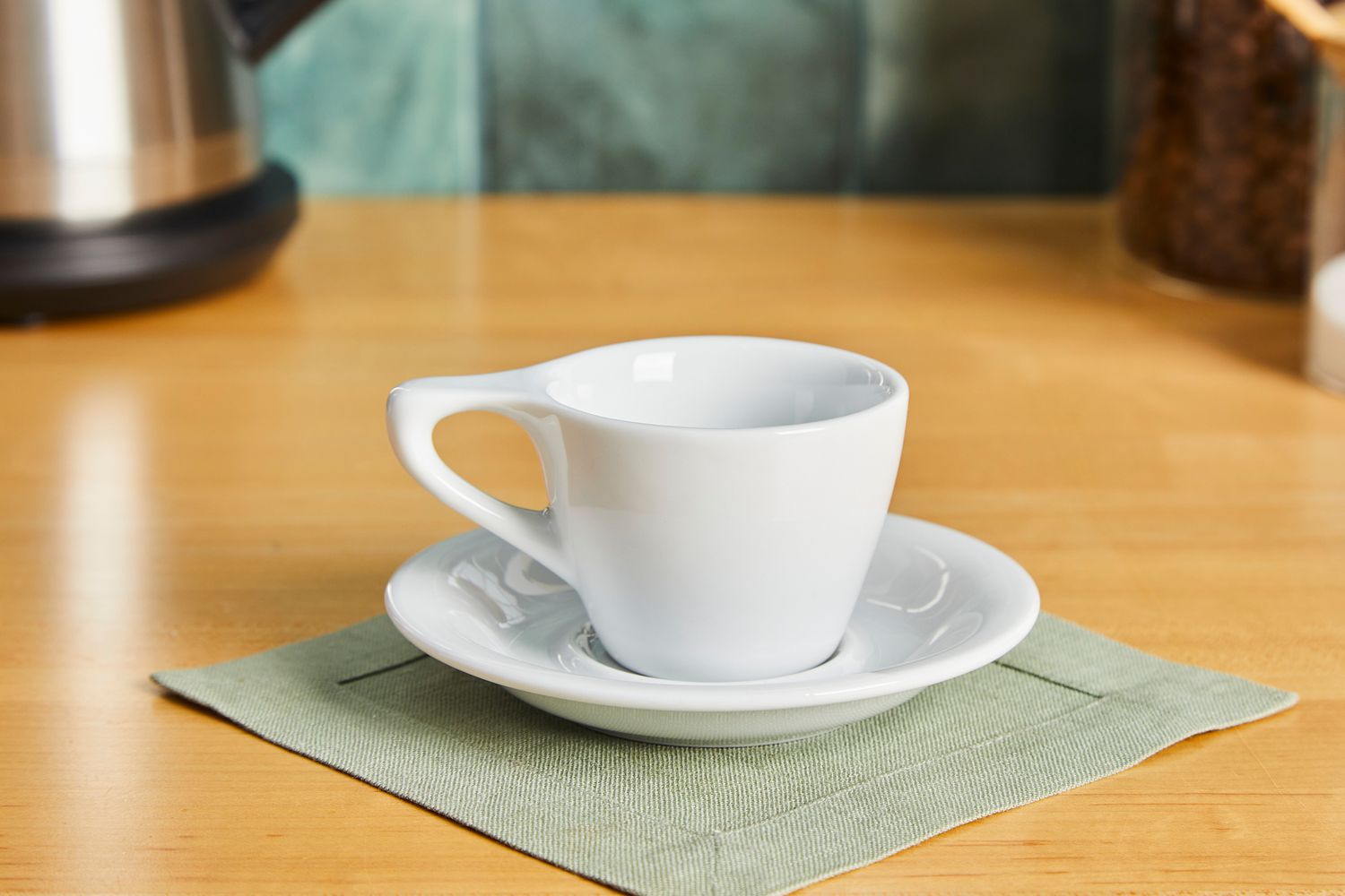 A white coffee mug on a saucer.