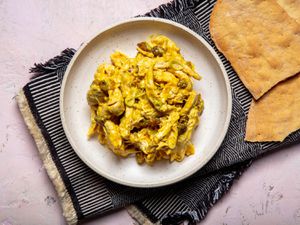 overhead shot of curry chicken salad on a beige plate