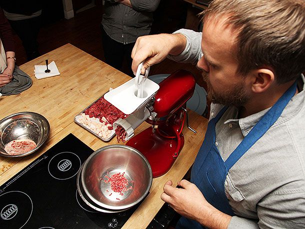 Grinding meat and fat into the bowl.