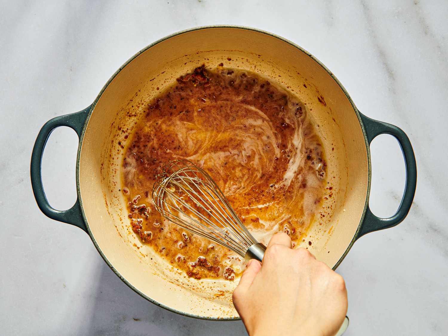 whisking flour into drippings to form a roux