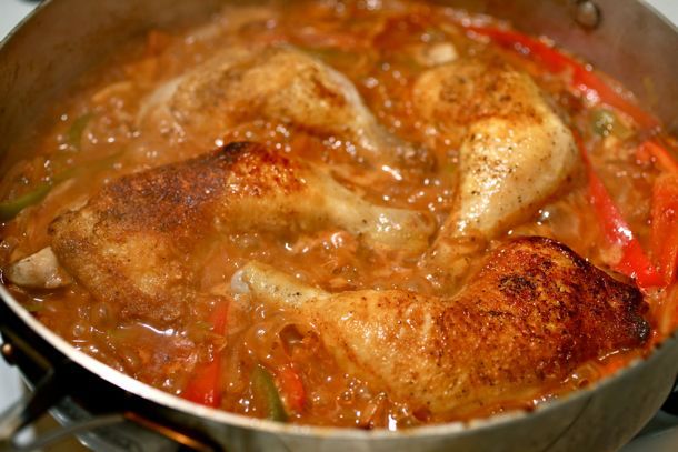 Skillet Braised Chicken with Peppers and Paprika in a large skillet, fresh from the oven.