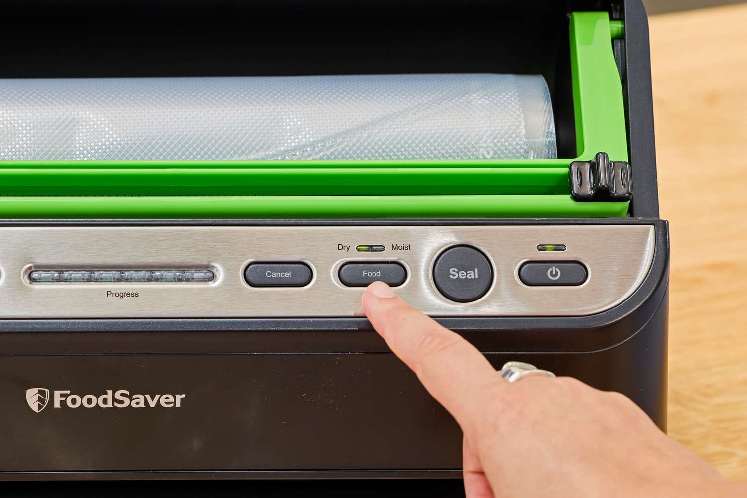 A close-up of the a button on the FoodSaver V4400 2-in-1 Vacuum Sealer Machine