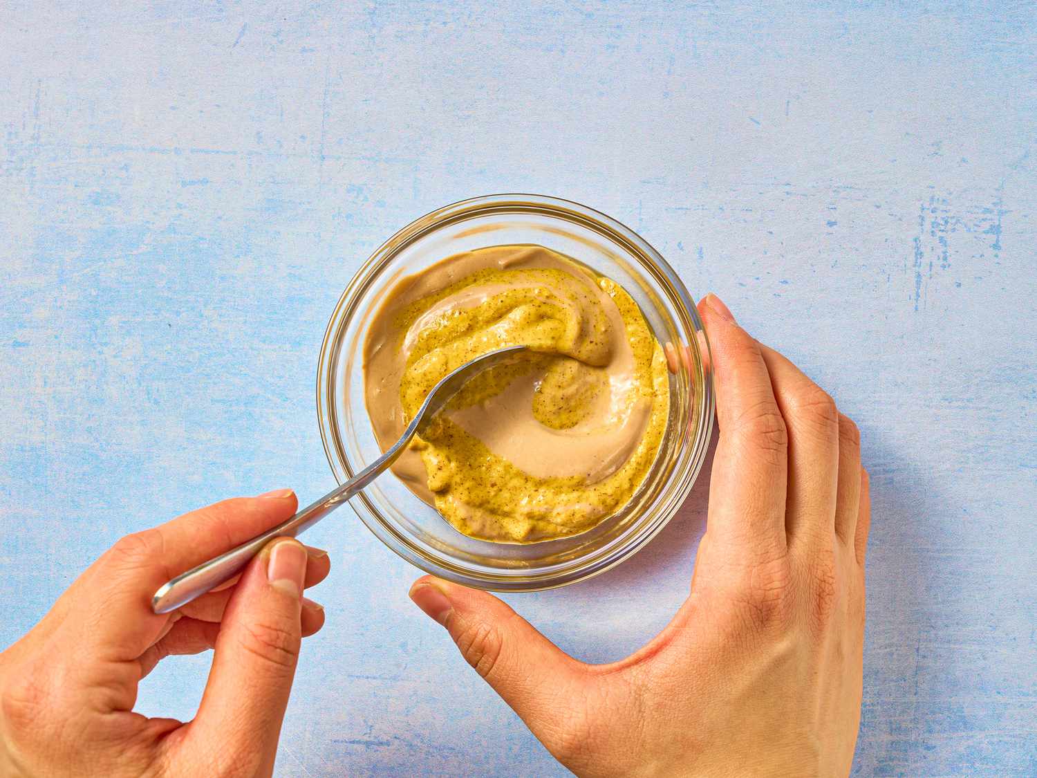 mixing mustards together in small dish 