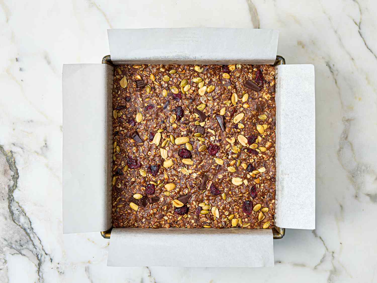 Pan of homemade protein bars with parchment paper liner