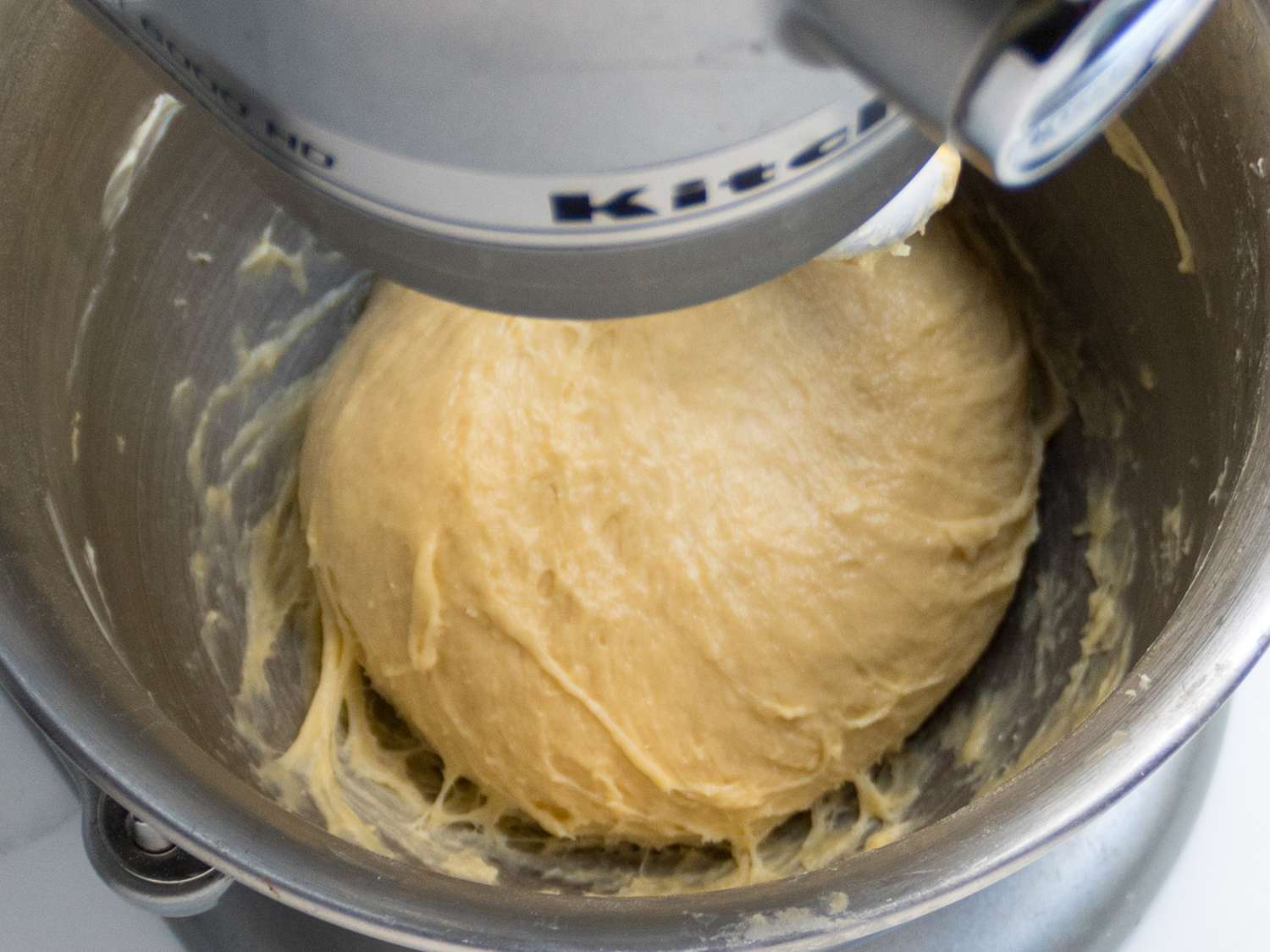 Stand mixer, with dough mixture, moist and webby