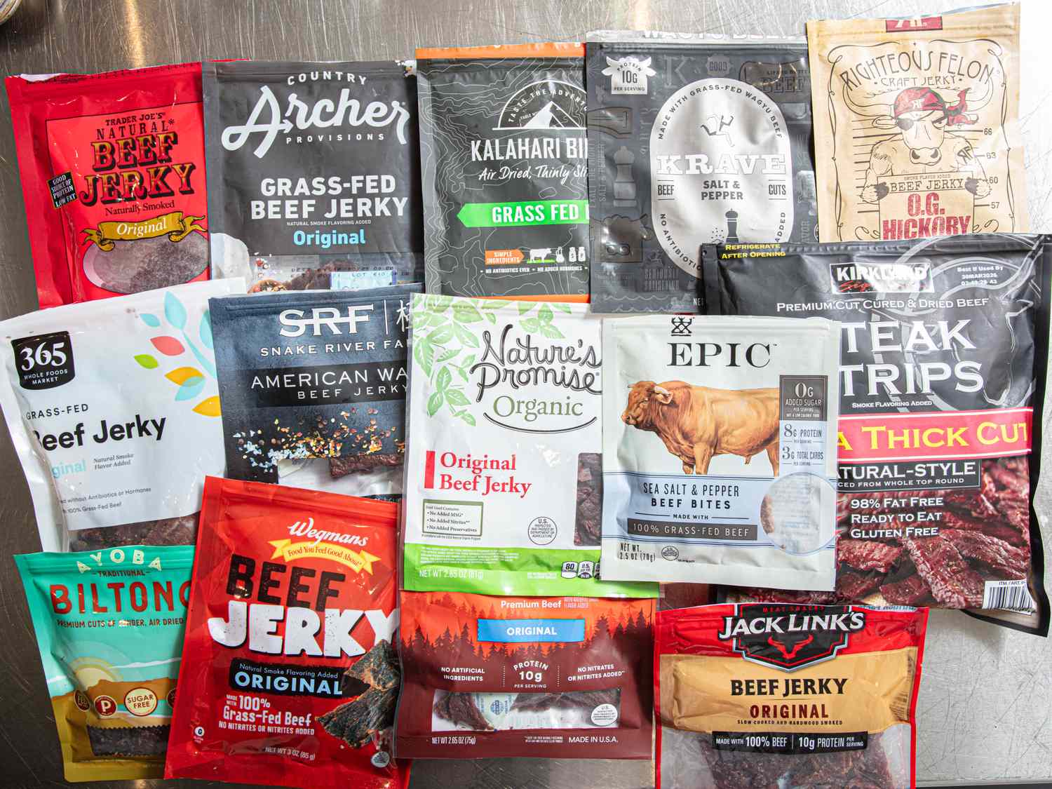 A display of various packaged beef jerky brands arranged on a table