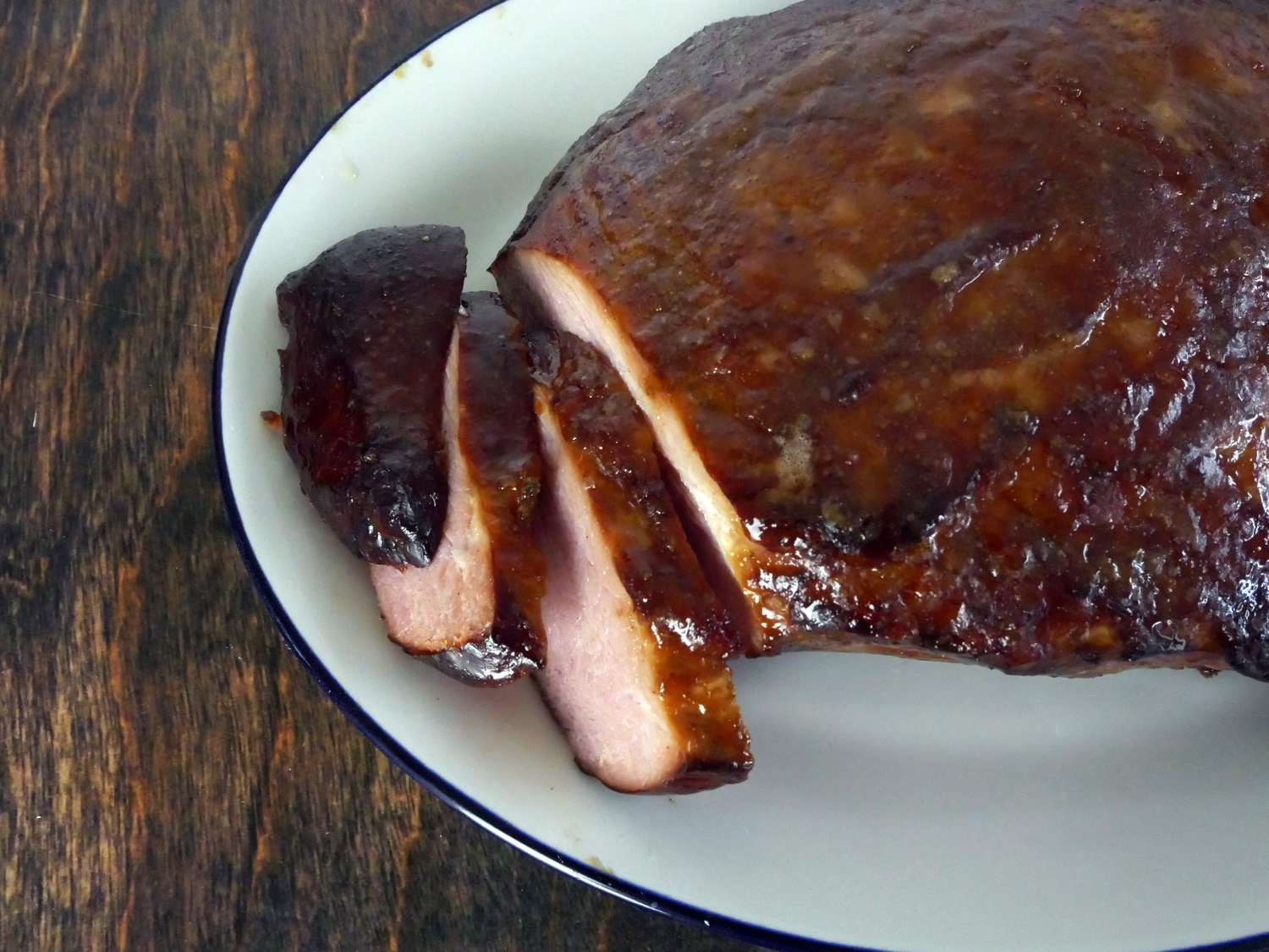 a closeup of three slices of Rastelli's ham on a platter